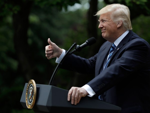 President Donald Trump signs an executive order aimed at easing an IRS rule limiting political activity for churches, in the Rose Garden of the White House, Thursday, May 4, 2017, in Washington. (AP Photo/Evan Vucci)