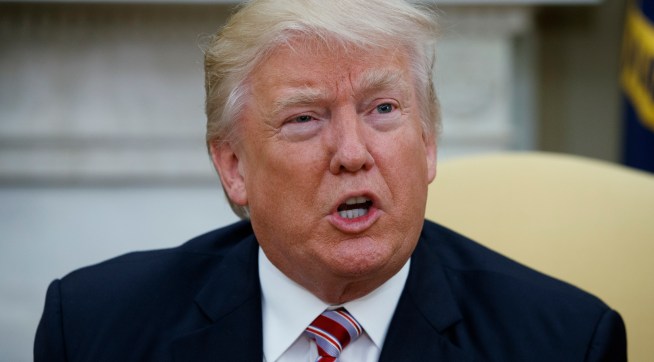 President Donald Trump talks to reporters during a meeting with former Secretary of State Henry Kissinger in the Oval Office of the White House, Wednesday, May 10, 2017, in Washington. (AP Photo/Evan Vucci)