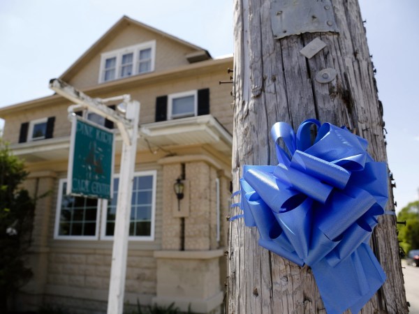 A blue ribbon adorns a telephone pole outside the Pine Kirk Care Center on Saturday, May 13, 2017 in Kirkersville, Ohio. The nursing home was the site of a fatal shooting on Friday, May 12, 2017 after Thomas Hartless, 43, of Utica, shot Kirkersville police chief Steven DiSario, nurse Marlina Medrano and nurse's aide Cindy Krantz. Hartless was later found dead inside the nursing home. [Joshua A. Bickel/Dispatch]