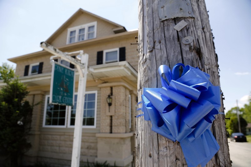 A blue ribbon adorns a telephone pole outside the Pine Kirk Care Center on Saturday, May 13, 2017 in Kirkersville, Ohio. The nursing home was the site of a fatal shooting on Friday, May 12, 2017 after Thomas Hartless, 43, of Utica, shot Kirkersville police chief Steven DiSario, nurse Marlina Medrano and nurse's aide Cindy Krantz. Hartless was later found dead inside the nursing home. [Joshua A. Bickel/Dispatch]