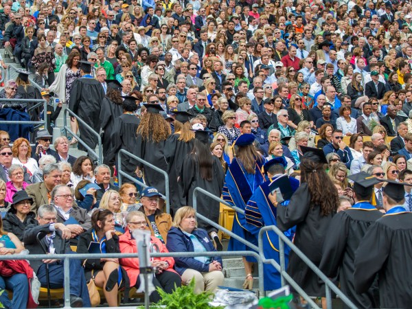 Notre Dame graduates walk out of Notre Dame Stadium in protest as Vice President Mike Pence begins to speak for the 2017 commencement ceremony Sunday, May 21, 2017, in South Bend, Ind. (Robert Franklin/South Bend Tribune via AP)