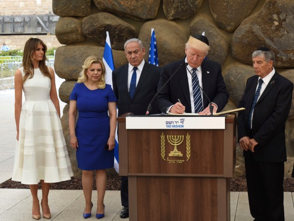 U.S. President Donald Trump signs the guest book at the Yad Vashem Holocaust Museum in Jerusalem, Israel, May 23, 2017. He is joined by his wife Melania, Sara Netanyahu, Israeli Prime Minister Benjamin Netanyahu and Yad Vashem Chairman Avner Shalev.  POOL  Photo by Debbie Hill/UPI