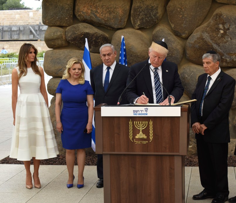 U.S. President Donald Trump signs the guest book at the Yad Vashem Holocaust Museum in Jerusalem, Israel, May 23, 2017. He is joined by his wife Melania, Sara Netanyahu, Israeli Prime Minister Benjamin Netanyahu and Yad Vashem Chairman Avner Shalev.  POOL  Photo by Debbie Hill/UPI