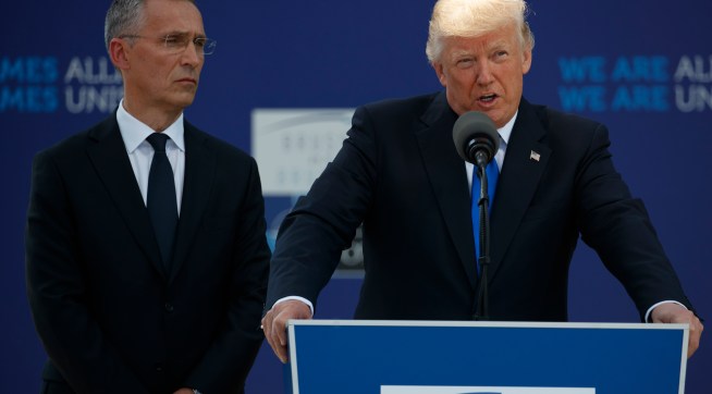 NATO Secretary General Jens Stoltenberg listens as President Donald Trump speaks during a ceremony to unveil artifacts from the World Trade Center and Berlin Wall for the new NATO headquarters, Thursday, May 25, 2017, in Brussels. (AP Photo/Evan Vucci)