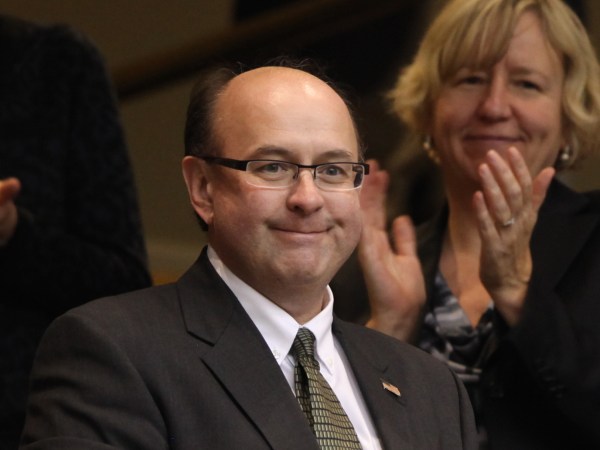 Newly-elected Secretary of State Matt Dunlap is stands after the results were announced Wednesday, Dec. 5, 2012  during a joint convention to elect constitutional officers in Augusta, Maine. (AP Photo/Joel Page)