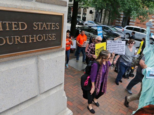 Protesters hold signs and march outside the US  4th Circuit Court of Appeals in Richmond, Va., Monday, May 8, 2017.  The court will examine a ruling that blocks the administration from temporarily barring new visas for citizens of Iran, Libya, Somalia, Sudan, Syria and Yemen. It's the first time an appeals court will hear arguments on the revised travel ban, which is likely destined for the U.S. Supreme Court.(AP Photo/Steve Helber)