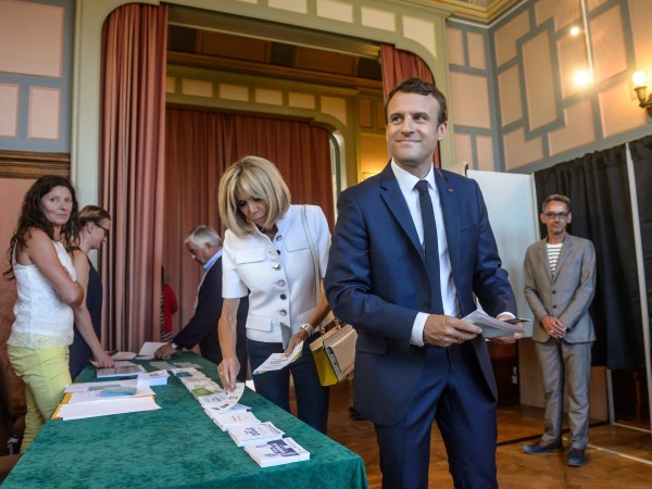 French President Emmanuel Macron and his wife Brigitte Macron pick up ballots before voting in the first round of the two-stage legislative elections in Le Touquet, northern France, Sunday, June 11, 2017. French voters are choosing legislators in the first round of parliamentary elections, with President Emmanuel Macron’s party "Republic on the Move" hoping to win a strong majority in the National Assembly to push through bold labor and security reforms. (Christophe Petit-Tesson/Pool Photo via AP)