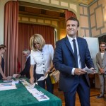 French President Emmanuel Macron and his wife Brigitte Macron pick up ballots before voting in the first round of the two-stage legislative elections in Le Touquet, northern France, Sunday, June 11, 2017. French voters are choosing legislators in the first round of parliamentary elections, with President Emmanuel Macron’s party "Republic on the Move" hoping to win a strong majority in the National Assembly to push through bold labor and security reforms. (Christophe Petit-Tesson/Pool Photo via AP)