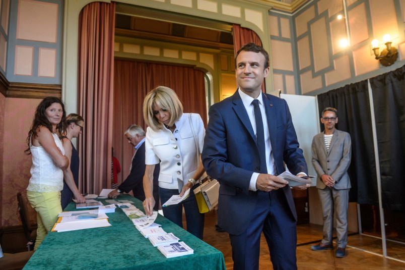 French President Emmanuel Macron and his wife Brigitte Macron pick up ballots before voting in the first round of the two-stage legislative elections in Le Touquet, northern France, Sunday, June 11, 2017. French voters are choosing legislators in the first round of parliamentary elections, with President Emmanuel Macron’s party "Republic on the Move" hoping to win a strong majority in the National Assembly to push through bold labor and security reforms. (Christophe Petit-Tesson/Pool Photo via AP)
