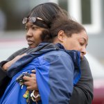 A family member comforts Monika Williams, front, after an officer-involved shooting killed her sister at the Brettler Family Place Apartments at Magnuson Park Sunday June 18, 2017. According to police, two officers responded to a burglary call made by the woman, who they say brandished a knife at some point, and both officers shot her dead in her apartment. Children were home at the time, but physically unharmed. â€œThereâ€™s no reason for her to be shot in front of her babies,â€ Williams yelled to reporters when she arrived on scene. â€œThe Seattle police shot the wrong one today.â€ OUTS: SEATTLE OUT, USA TODAY OUT, MAGAZINES OUT, ONLINE OUT, TELEVISION OUT, SALES OUT. MANDATORY CREDIT TO: Bettina Hansen / THE SEATTLE TIMES.