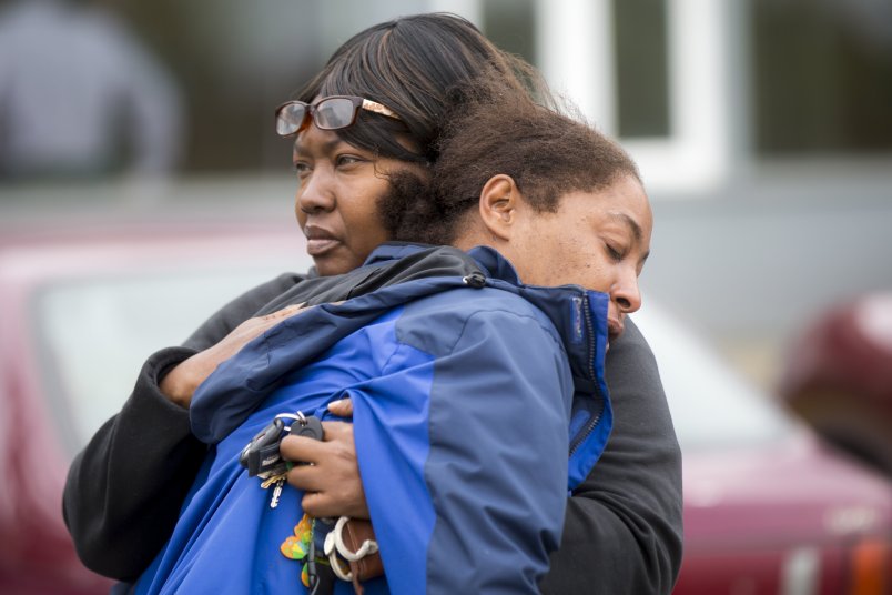 A family member comforts Monika Williams, front, after an officer-involved shooting killed her sister at the Brettler Family Place Apartments at Magnuson Park Sunday June 18, 2017. According to police, two officers responded to a burglary call made by the woman, who they say brandished a knife at some point, and both officers shot her dead in her apartment. Children were home at the time, but physically unharmed. â€œThereâ€™s no reason for her to be shot in front of her babies,â€ Williams yelled to reporters when she arrived on scene. â€œThe Seattle police shot the wrong one today.â€ OUTS: SEATTLE OUT, USA TODAY OUT, MAGAZINES OUT, ONLINE OUT, TELEVISION OUT, SALES OUT. MANDATORY CREDIT TO: Bettina Hansen / THE SEATTLE TIMES.