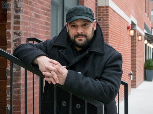 In this Jan. 9, 2017, photo, Christian Picciolini, founder of the group Life After Hate, poses for a photograph outside his Chicago home. Picciolini, a former skinhead, is an activist combatting what many see as a surge in white nationalism across the United States. He's doing it by helping members quit groups including the Ku Klux Klan and skinhead organizations. (AP Photo/Teresa Crawford)