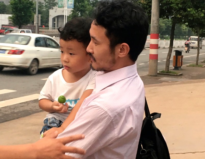 Chinese labor activist Hua Haifeng, center, carries his son Bobo chats with his sister Hua Xiaoqin, left, as they leave a police station after being released in Ganzhou in southern China's Jiangxi Province, Wednesday, June 28, 2017. Chinese authorities have released on bail three activists who had been detained after investigating labor conditions at a factory that produced shoes for Ivanka Trump and other brands. (AP Photo/Gerry Shih)
