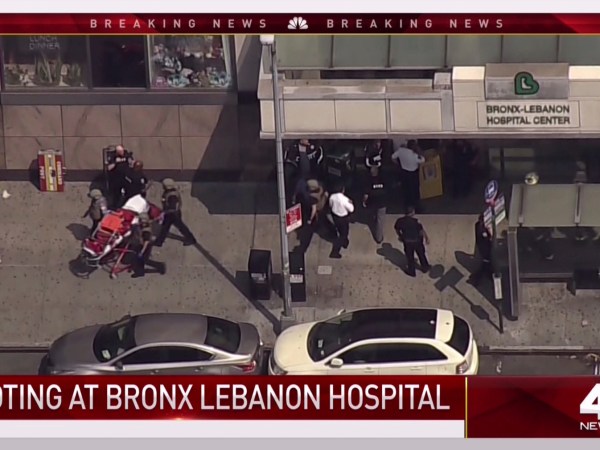 In this image taken from video provided by WNBC 4 New York, emergency personnel converge on Bronx Lebanon Hospital in New York, Friday, June 30, 2017. Police say at least two people have been shot at a New York City hospital and the gunman is still at large. (NBC 4 New York via AP)