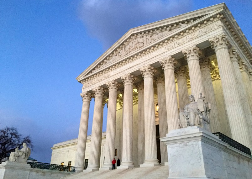 People stand on the steps of the Supreme Court at sunset on Saturday, Feb. 13, 2016, in Washington. On Saturday, Feb. 13, 2016, the U.S. Marshals Service confirmed that Scalia has died at the age of 79. (AP Photo/Jon Elswick)