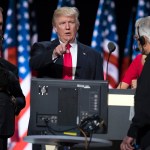 Republican presidential candidate Donald Trump, center, talks with production crew during a walk through in preparation for his speech at the Republican National Convention, Thursday, July 21, 2016, in Cleveland. (AP Photo/Evan Vucci)