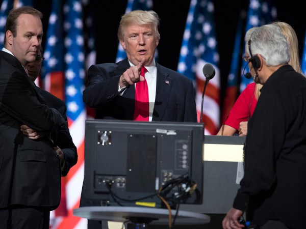 Republican presidential candidate Donald Trump, center, talks with production crew during a walk through in preparation for his speech at the Republican National Convention, Thursday, July 21, 2016, in Cleveland. (AP Photo/Evan Vucci)