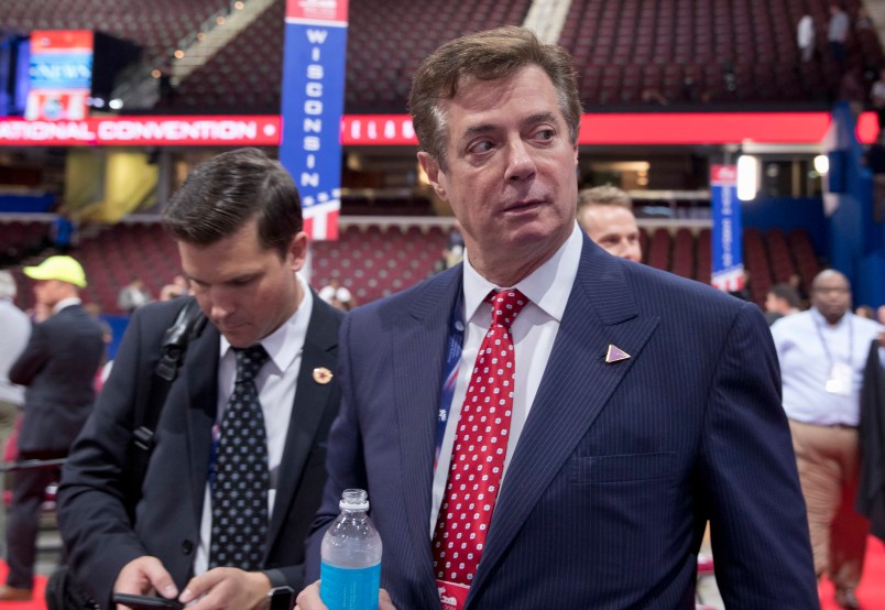 FILE - In this July 18, 2016, file photo, Trump campaign chairman Paul Manafort walks around the convention floor before the opening session of the Republican National Convention in Cleveland. Hillary Clinton’s campaign is questioning Donald Trump’s top political aide’s ties to a pro-Kremlin political party in Ukraine, claiming it is evidence of the Republican nominee’s cozy relationship with Russia. The New York Times reported that handwritten ledgers found in Ukraine show $12.7 million in undisclosed payments to Paul Manafort from the pro-Russia party founded by the country’s former president Viktor Yanukovych. (AP Photo/Carolyn Kaster, File)