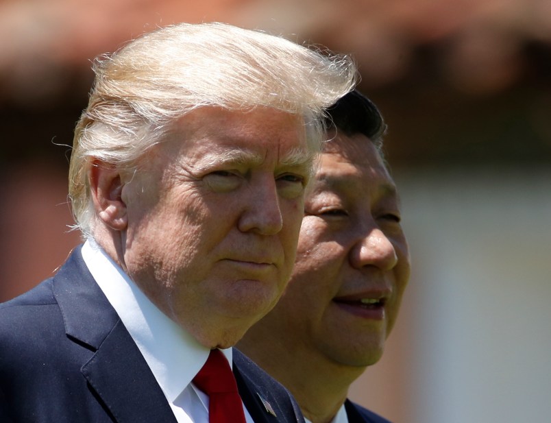 President Donald Trump and Chinese President Xi Jinping walk together at Mar-a-Lago, Friday, April 7, 2017, in Palm Beach, Fla. Trump was meeting again with his Chinese counterpart Friday, with U.S. missile strikes on Syria adding weight to his threat to act unilaterally against the nuclear weapons program of China's ally, North Korea. (AP Photo/Alex Brandon)