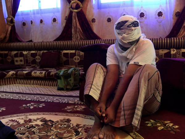 In this May 11 2017 photo, a former detainee speaks after covering his face for fear of detention. He recounted the torment he suffered in Riyan prison where hundreds of terror suspects are held without trial after being rounded up by local Yemeni forces loyal to the United Arab Emiratis in the southern city of Mukalla. Former detainees report brutal torture, and families search desperately for loved ones who have disappeared. Some including have been flown to ships in the sea and an Emirati base in the nearby Horn of Africa. (AP Photo/Maad El Zikry)