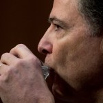 Former FBI Director James Comey takes a drink of water as he testifies at a Senate Intelligence Committee hearing on Capitol Hill, Thursday, June 8, 2017, in Washington. (AP Photo/Andrew Harnik)