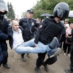 Police detain a protester during anti corruption rally in St.Petersburg, Russia, Monday, June 12, 2017. Riot police in St. Petersburg have begun detaining demonstrators in an unsanctioned opposition rally in the center of the city. (AP Photo/Dmitry Lovetsky)