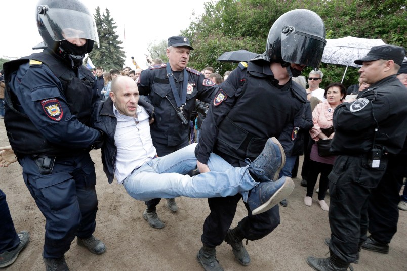 Police detain a protester during anti corruption rally in St.Petersburg, Russia, Monday, June 12, 2017. Riot police in St. Petersburg have begun detaining demonstrators in an unsanctioned opposition rally in the center of the city. (AP Photo/Dmitry Lovetsky)
