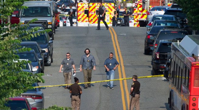 Police and emergency personnel are seen near the scene where House Majority Whip Steve Scalise of La. was shot during a Congressional baseball practice in Alexandria, Va., Wednesday, June 14, 2017.  (AP Photo/Cliff Owen)