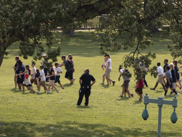 Tourists are directed away from the Capitol Building and across the lawn by U.S. Capitol Police officers after Rep. Steve Scalise, who is the majority whip, and a number of aides and officers were injured Wednesday morning in a shooting at a congressional baseball game in Alexandria, Va., in Washington, Wednesday, June 14, 2017. (AP Photo/J. Scott Applewhite)