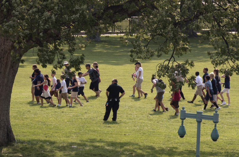 Tourists are directed away from the Capitol Building and across the lawn by U.S. Capitol Police officers after Rep. Steve Scalise, who is the majority whip, and a number of aides and officers were injured Wednesday morning in a shooting at a congressional baseball game in Alexandria, Va., in Washington, Wednesday, June 14, 2017. (AP Photo/J. Scott Applewhite)