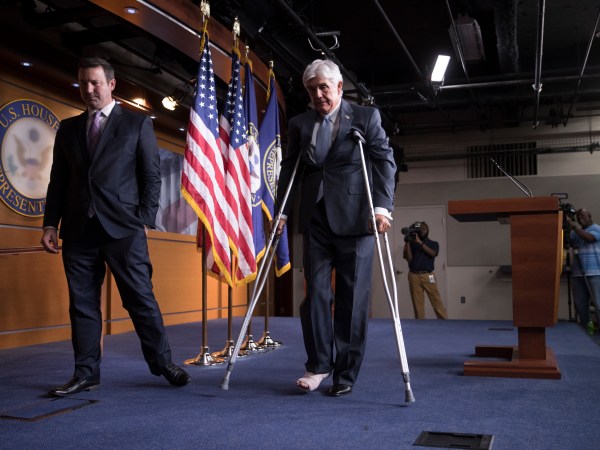 Rep. Roger Williams, R-Texas, who injured his ankle during a shooting at a congressional baseball game, leaves a news conference on crutches, assisted by his aide J. Spencer Freebairn, left, at the Capitol in Washington, Wednesday, June 14, 2017.  (AP Photo/J. Scott Applewhite)