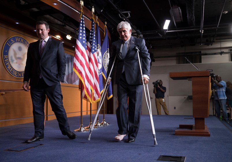 Rep. Roger Williams, R-Texas, who injured his ankle during a shooting at a congressional baseball game, leaves a news conference on crutches, assisted by his aide J. Spencer Freebairn, left, at the Capitol in Washington, Wednesday, June 14, 2017.  (AP Photo/J. Scott Applewhite)