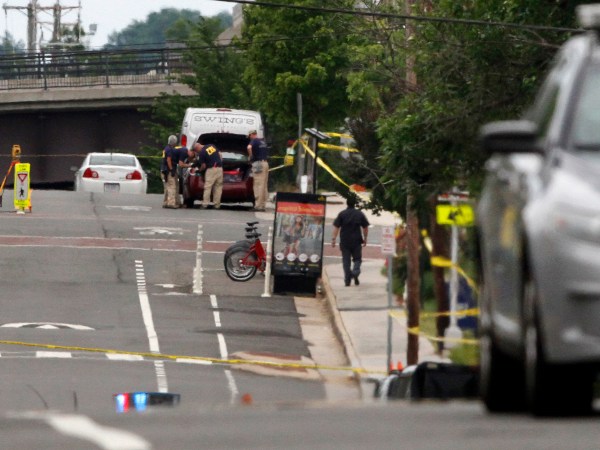FBI Agents investigate a car on E. Monroe Ave. in Alexandria, Va., Thursday, June 15, 2017, the day after House Majority Whip Steve Scalise of La. was shot during during a congressional baseball practice nearby. (AP Photo/Jacquelyn Martin)