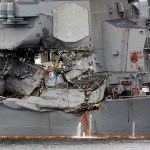 Damaged part of USS Fitzgerald is seen at the U.S. Naval base in Yokosuka, southwest of Tokyo Sunday, June 18, 2017.  Navy divers found a number of sailors' bodies Sunday aboard the stricken USS Fitzgerald that collided with a container ship in the busy sea off Japan, but a spokeswoman said not all seven missing had been accounted for. (AP Photo/Eugene Hoshiko)