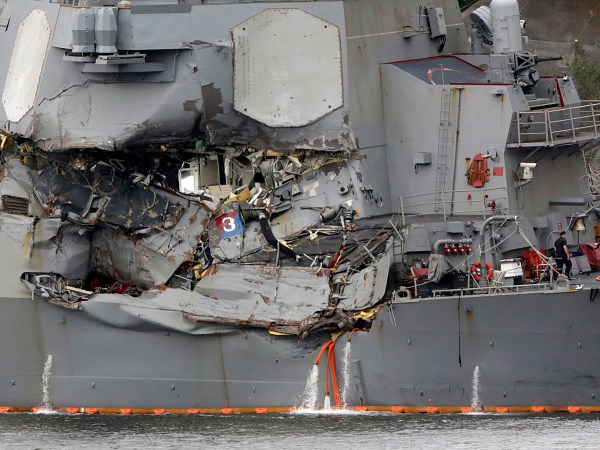 Damaged part of USS Fitzgerald is seen at the U.S. Naval base in Yokosuka, southwest of Tokyo Sunday, June 18, 2017.  Navy divers found a number of sailors' bodies Sunday aboard the stricken USS Fitzgerald that collided with a container ship in the busy sea off Japan, but a spokeswoman said not all seven missing had been accounted for. (AP Photo/Eugene Hoshiko)