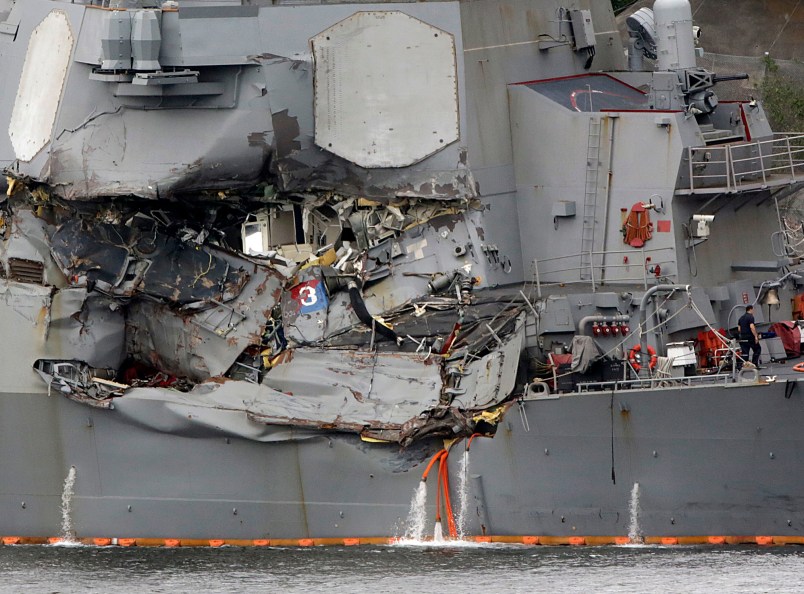 Damaged part of USS Fitzgerald is seen at the U.S. Naval base in Yokosuka, southwest of Tokyo Sunday, June 18, 2017.  Navy divers found a number of sailors' bodies Sunday aboard the stricken USS Fitzgerald that collided with a container ship in the busy sea off Japan, but a spokeswoman said not all seven missing had been accounted for. (AP Photo/Eugene Hoshiko)