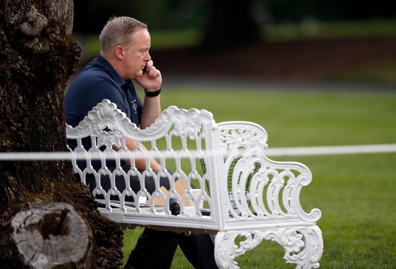 White House Press Secretary Sean Spicer talks on a phone during the Congressional Picnic on the South Lawn of the White House, Thursday, June 22, 2017, in Washington. (AP Photo/Alex Brandon)