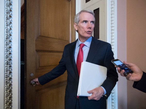 FILE - In this Tuesday, June 20, 2017 file photo, Sen. Rob Portman, R-Ohio, pauses for a reporter's question as he arrives at a closed-door GOP strategy session on the Republican health care overhaul with Vice President Mike Pence, Senate Majority Leader Mitch McConnell, R-Ky., and others, at the Capitol in Washington. Days after it's release, Portman faces intense pressure back home to oppose the Senate’s GOP health care bill. (AP Photo/J. Scott Applewhite)