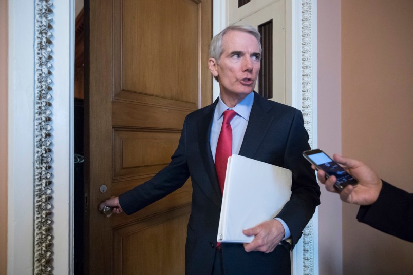 FILE - In this Tuesday, June 20, 2017 file photo, Sen. Rob Portman, R-Ohio, pauses for a reporter's question as he arrives at a closed-door GOP strategy session on the Republican health care overhaul with Vice President Mike Pence, Senate Majority Leader Mitch McConnell, R-Ky., and others, at the Capitol in Washington. Days after it's release, Portman faces intense pressure back home to oppose the Senate’s GOP health care bill. (AP Photo/J. Scott Applewhite)