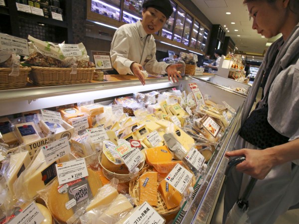 WAIT FOR A STORY; A customer looks at imported cheese at department store in Tokyo, Saturday, July 1, 2017. (AP Photo/Koji Sasahara)