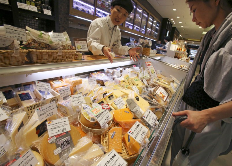 WAIT FOR A STORY; A customer looks at imported cheese at department store in Tokyo, Saturday, July 1, 2017. (AP Photo/Koji Sasahara)