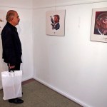 A visitor looks at a cartoon mocking the U.S. President Donald Trump in an exhibition in Tehran, Iran, Monday, July 3, 2017. Iranians have organized a "Trumpism" cartoon contest in which hundreds of participants have been invited to submit artwork mocking the U.S. leader. (AP Photo/Vahid Salemi)
