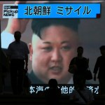 People walk past a TV news showing an image of North Korean leader Kim Jong Un while reporting North Korea's missile test which landed in the waters of Japan's economic zone (EEZ) in Tokyo Tuesday, July 4, 2017.  (AP Photo/Eugene Hoshiko)