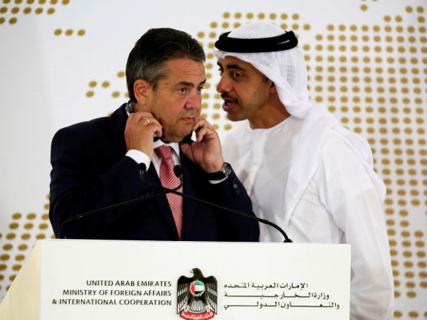 Emirati Foreign Minister Abdullah bin Zayed Al Nahyan whispers to German Foreign Minister Sigmar Gabriel during a news conference at the United Arab Emirates' Foreign Ministry in Abu Dhabi, United Arab Emirates, Tuesday, July 4, 2017. Al Nahyan met with Gabriel and talked to journalists about the ongoing diplomatic crisis engulfing Qatar. (AP Photo/Jon Gambrell)