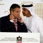 Emirati Foreign Minister Abdullah bin Zayed Al Nahyan whispers to German Foreign Minister Sigmar Gabriel during a news conference at the United Arab Emirates' Foreign Ministry in Abu Dhabi, United Arab Emirates, Tuesday, July 4, 2017. Al Nahyan met with Gabriel and talked to journalists about the ongoing diplomatic crisis engulfing Qatar. (AP Photo/Jon Gambrell)