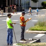 --PLEASE HOLD-- In a photo taken Wednesday, July 5, 2017, two men survey an area in the parking lot of Monmouth Mall in Eatontown, N.J. Four local women are the plaintiffs in a court case against Jared Kushner, who is trying to expand the mall and build an apartment complex. Residents are upset because the complex encroaches onto their backyards and it will bring unwanted traffic and noise to the town. The plaintiffs claim Kushner is getting special treatment as the project has sped through the process in a rare manner. (AP Photo/Julio Cortez)