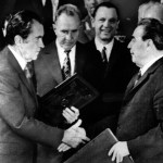 President Richard M. Nixon shakes hands with Communist Party leader Leonid Brezhnev on May 29, 1972 in Moscow after the two  signed a joint statement of long-range principles agreeing to avoid millitary confrontations and envisioning total world disarmament.  Premier Alexei Kosygin is at left center behind President Nixon's copy of the treaty.  (AP Photo/stf)