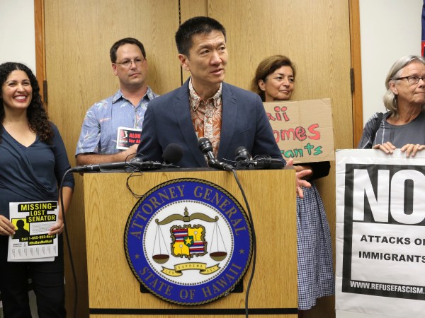Hawaii Attorney General Douglas Chin speaks at a news conderence about President Donald Donald Trump’s travel ban, Friday, June 30, 2017 in Honolulu. Chin says the scaled-back version of Trump's travel ban has illogical standards for who should be prohibited from entering the country. Chin questioned why a stepbrother or stepsister should be allowed into the country but not a grandmother. The Trump administration set new criteria Thursday barring some citizens from six majority-Muslim countering from coming to the United States. (AP Photo/Caleb Jones)
