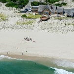 In this Sunday, July 2, 2017, photo, New Jersey Gov. Chris Christie uses the beach with his family and friends at the governor's summer house at Island Beach State Park in New Jersey. Christie is defending his use of the beach, closed to the public during New Jersey's government shutdown, saying he had previously announced his vacation plans and the media had simply "caught a politician keeping his word." (Andrew Mills/NJ Advance Media via AP)