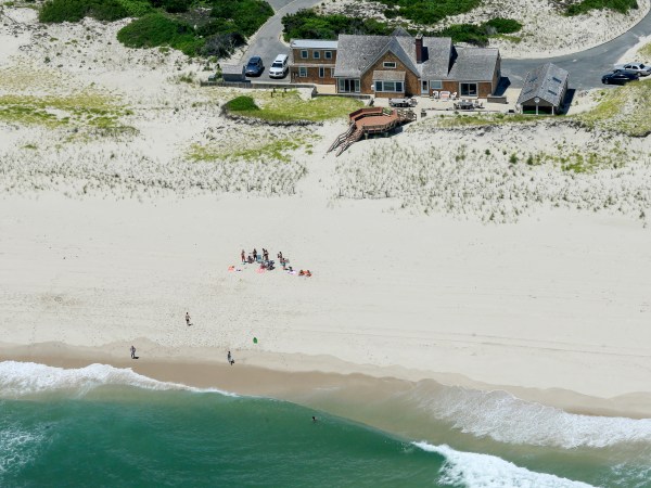 In this Sunday, July 2, 2017, photo, New Jersey Gov. Chris Christie uses the beach with his family and friends at the governor's summer house at Island Beach State Park in New Jersey. Christie is defending his use of the beach, closed to the public during New Jersey's government shutdown, saying he had previously announced his vacation plans and the media had simply "caught a politician keeping his word." (Andrew Mills/NJ Advance Media via AP)